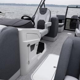 Spacious helm seating and console layout aboard the Alera Model M 23Q — premium vinyl upholstery meets functional design.